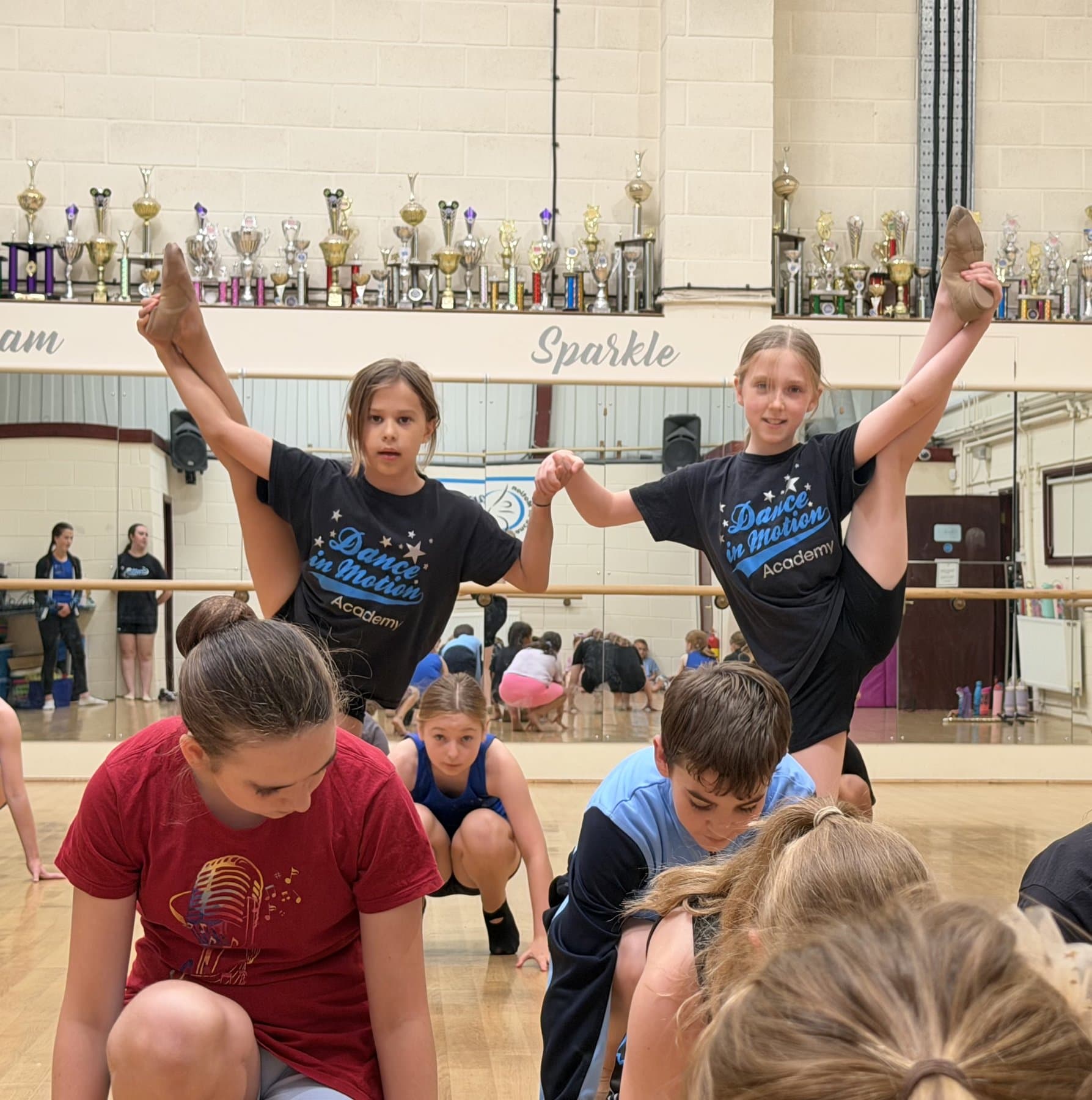 Holiday camp dancers stretching in the studio
