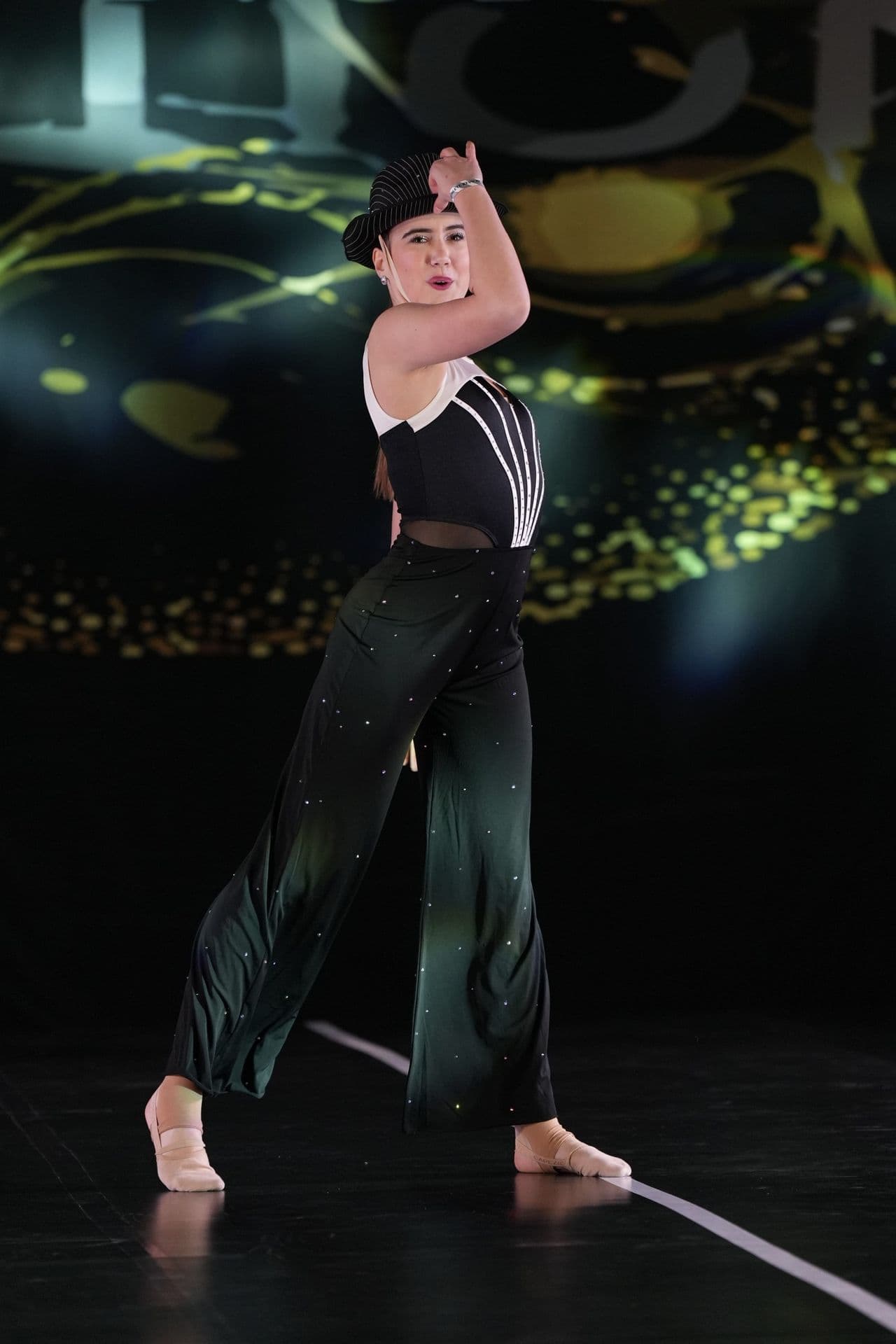 Jazz dancer in a fedora performing on stage