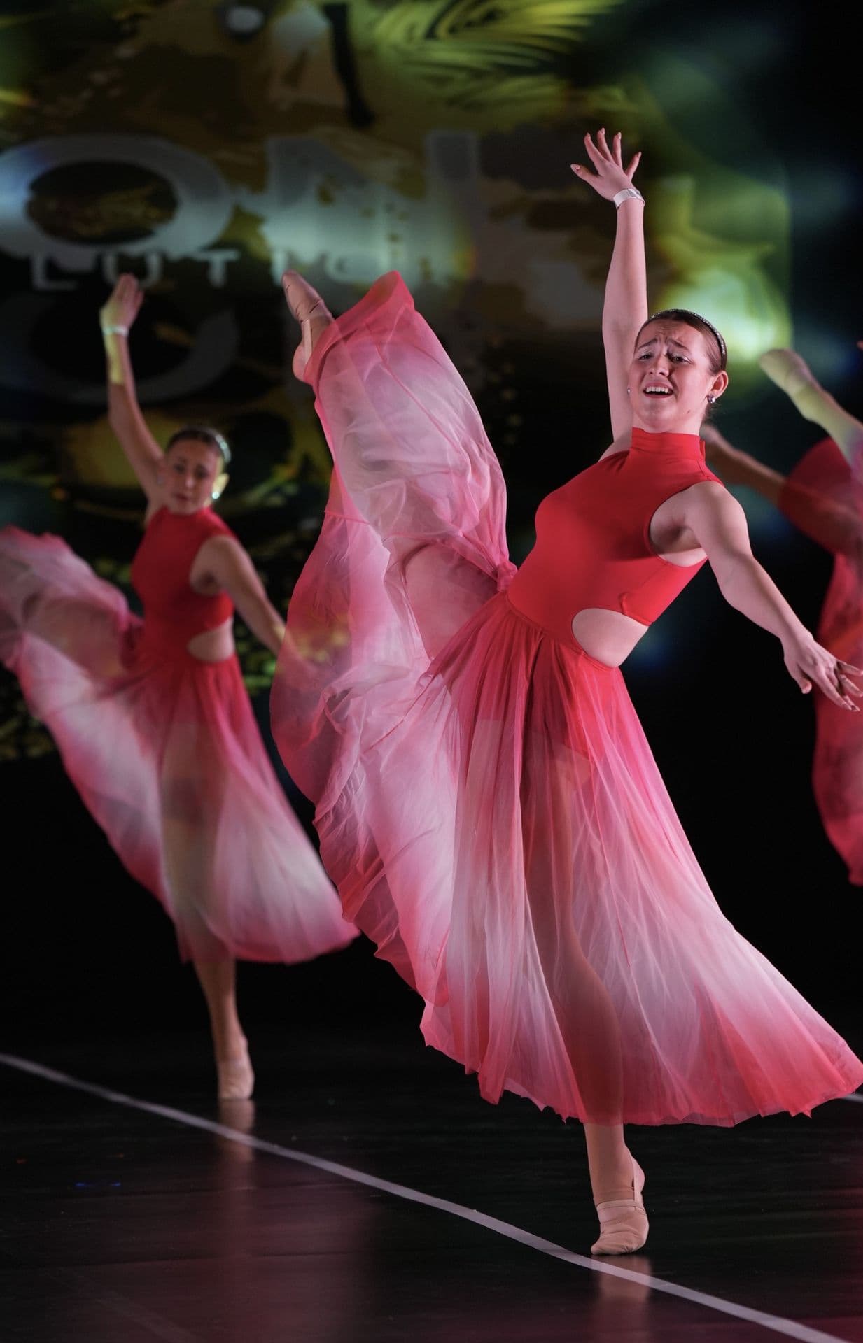 Lyrical dancer in a flowing pink dress on stage