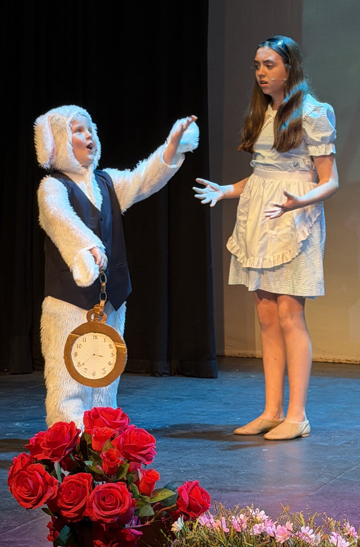 Alice and the White Rabbit on stage in Alice in Wonderland Jr